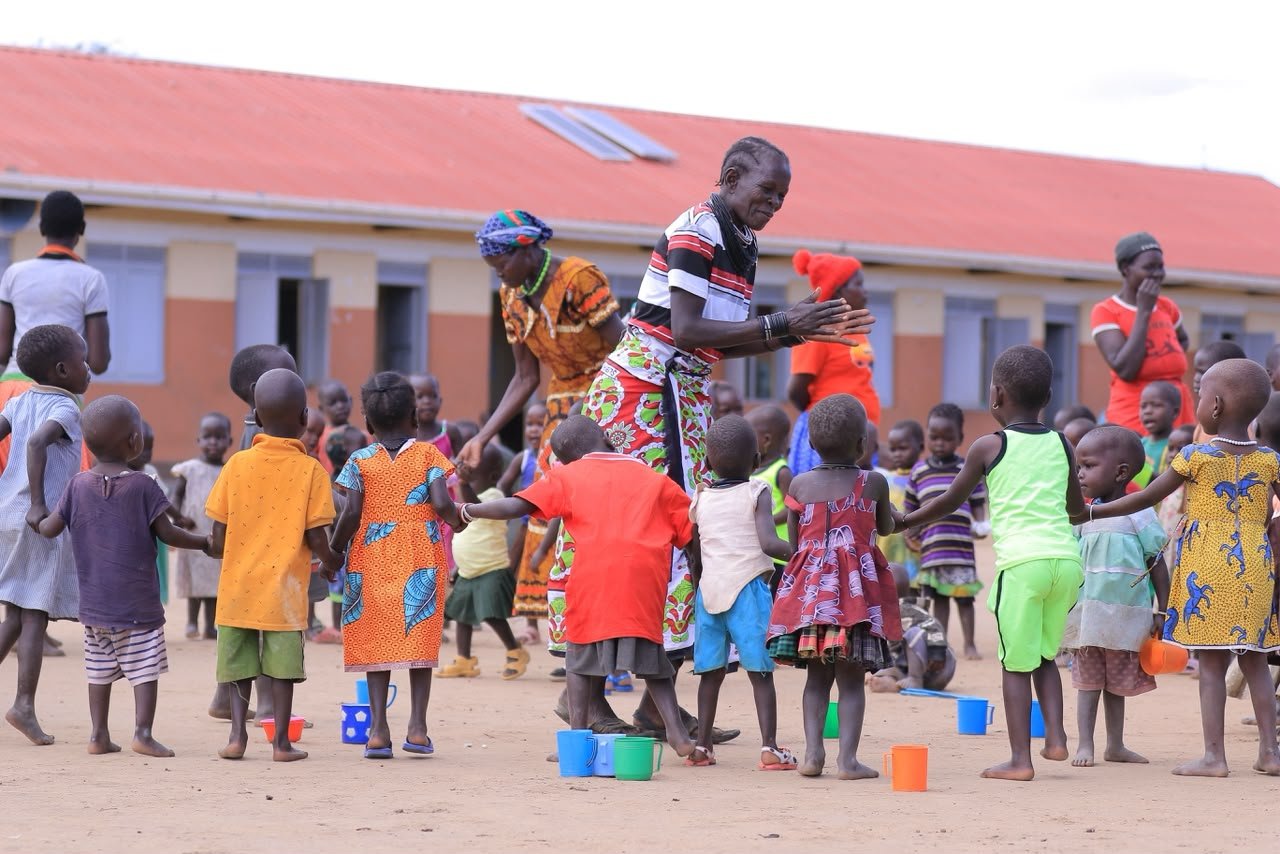 Children and a facilitator taking part in a community activity