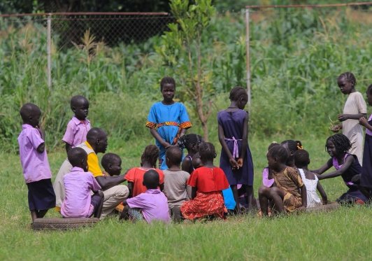 Children gathered outdoors for a learning activity