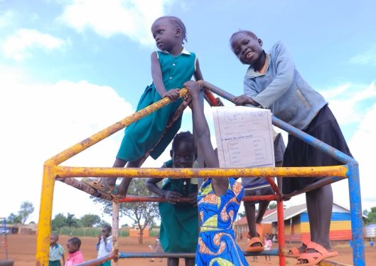 Children playing on community playground equipment